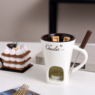 White fondue mug with chocolate and a lit tealight